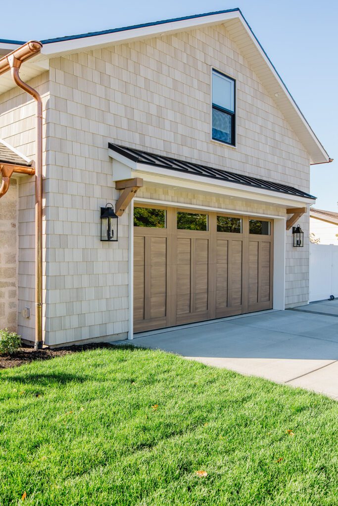 Front elevation of a Utah custom home featuring wood accents, clean lines, and detailed landscaping
