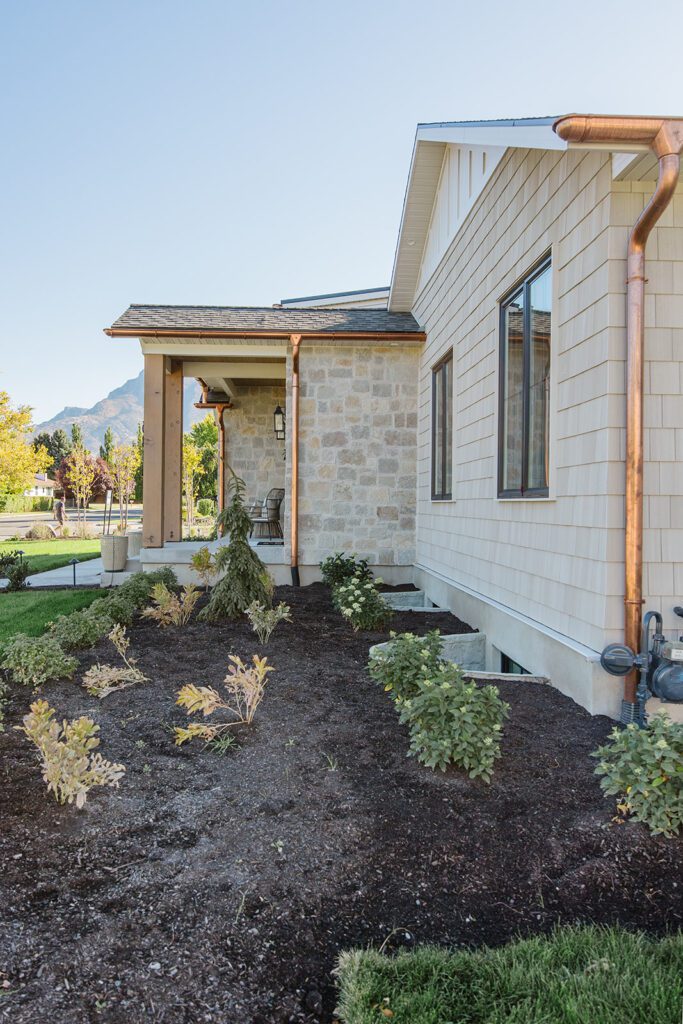 Exterior view of the Campbell Project, a custom home built in Utah with warm stone and timeless architecture.