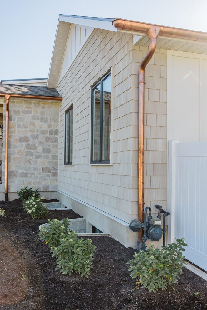 Exterior view of the Campbell Project, a custom home built in Utah with warm stone and timeless architecture.