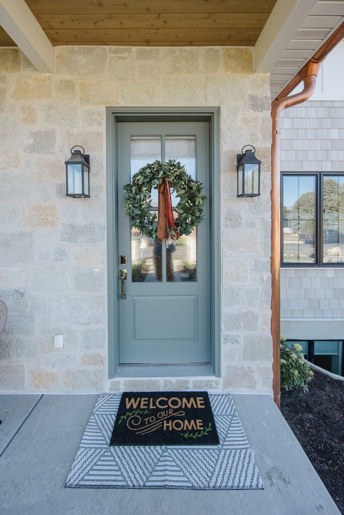 Exterior view of the Campbell Project, a custom home built in Utah with warm stone and timeless architecture.