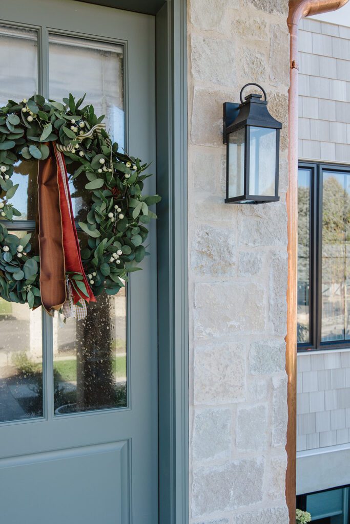 Exterior view of the Campbell Project, a custom home built in Utah with warm stone and timeless architecture.