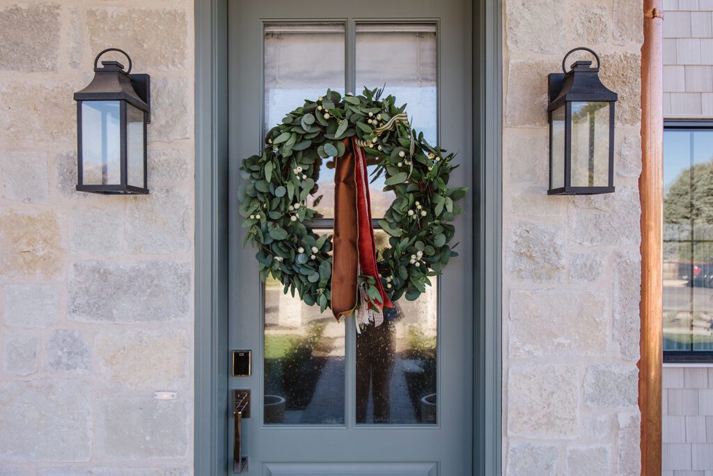 Front elevation of a Utah custom home featuring wood accents, clean lines, and detailed landscaping.