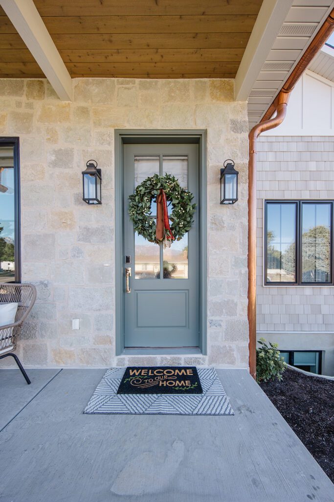 Exterior view of the Campbell Project, a custom home built in Utah with warm stone and timeless architecture.