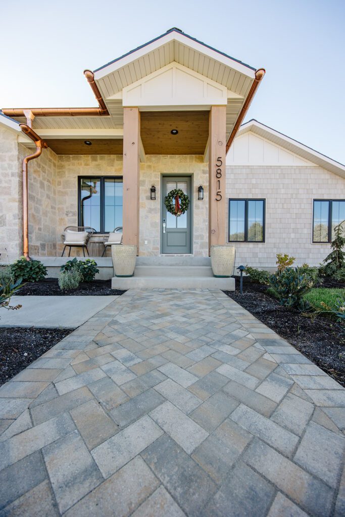 Exterior view of the Campbell Project, a custom home built in Utah with warm stone and timeless architecture.