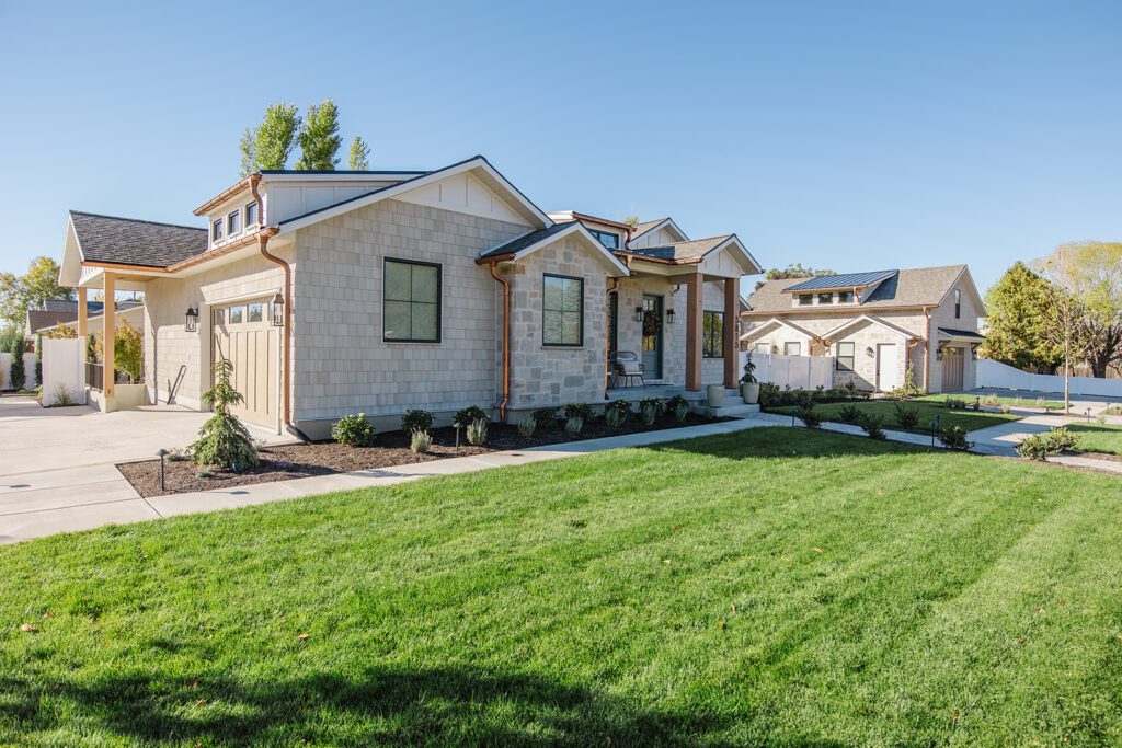 Exterior view of the Campbell Project, a custom home built in Utah with warm stone and timeless architecture.
