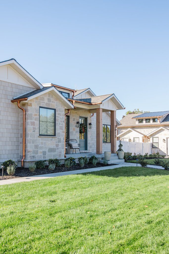 Exterior view of the Campbell Project, a custom home built in Utah with warm stone and timeless architecture.