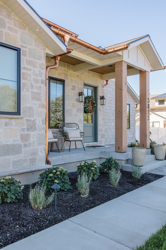 Front elevation of a Utah custom home featuring wood accents, clean lines, and detailed landscaping.