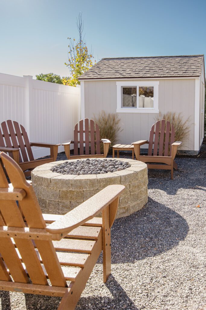 Back exterior of a Utah custom home with large windows, patio space, and beautiful yard design
