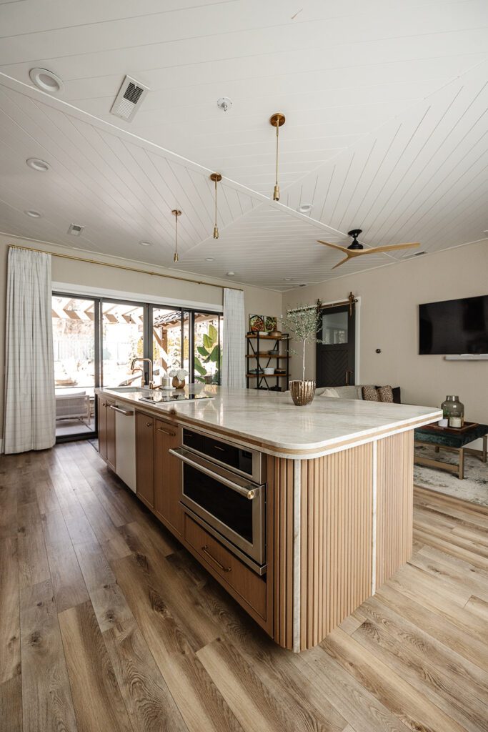 Luxury chef’s kitchen with large island and mixed textures in The Recipe Critic’s Alpine studio