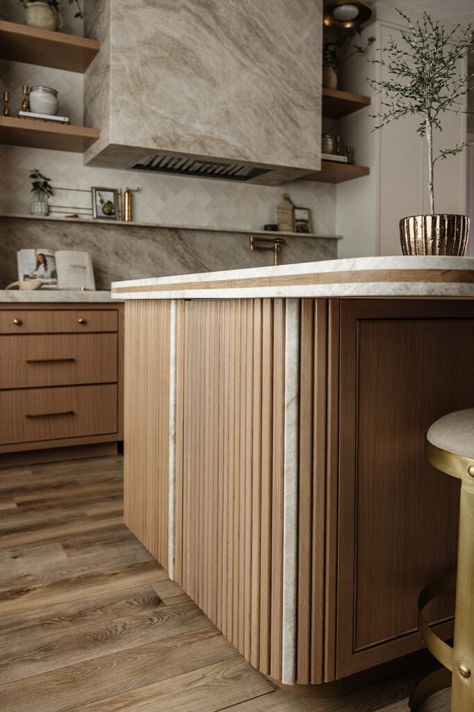 Luxury chef’s kitchen with large island and mixed textures in The Recipe Critic’s Alpine studio