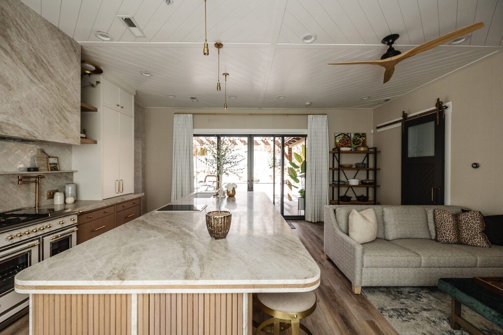 Luxury chef’s kitchen with large island and mixed textures in The Recipe Critic’s Alpine studio